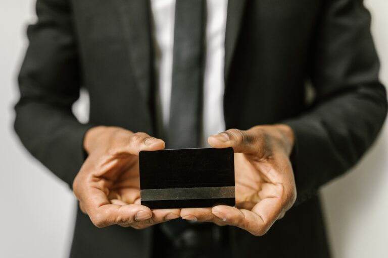 Man in suite holding credit card